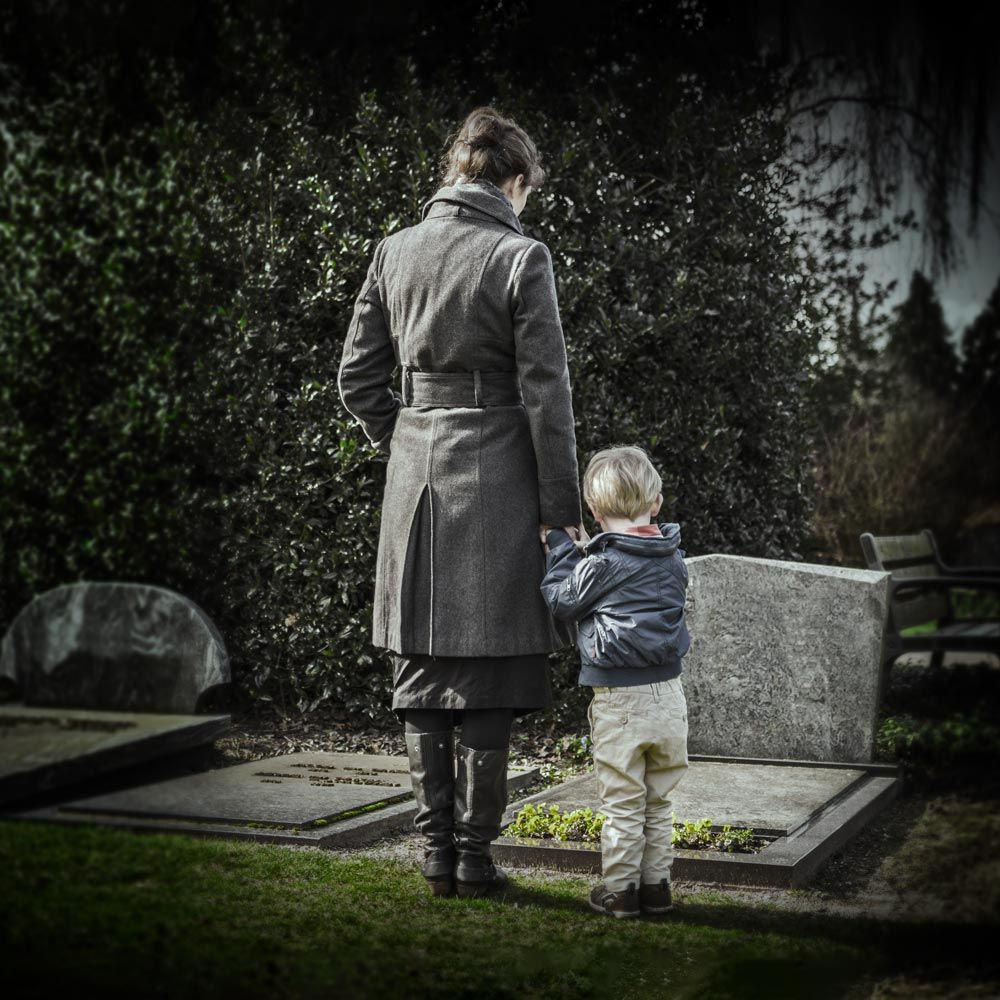 Father and young son at gravesite